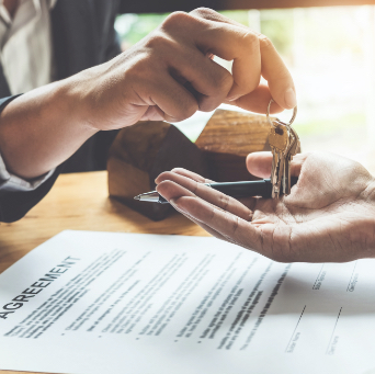 Image of person handing over keys