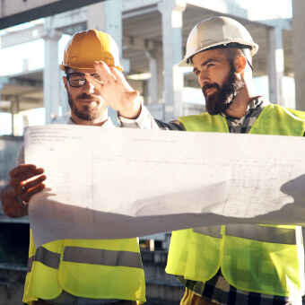 Two construction workers looking at a blueprint